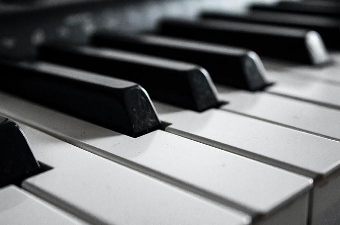 A black and white macro photo of piano keys.